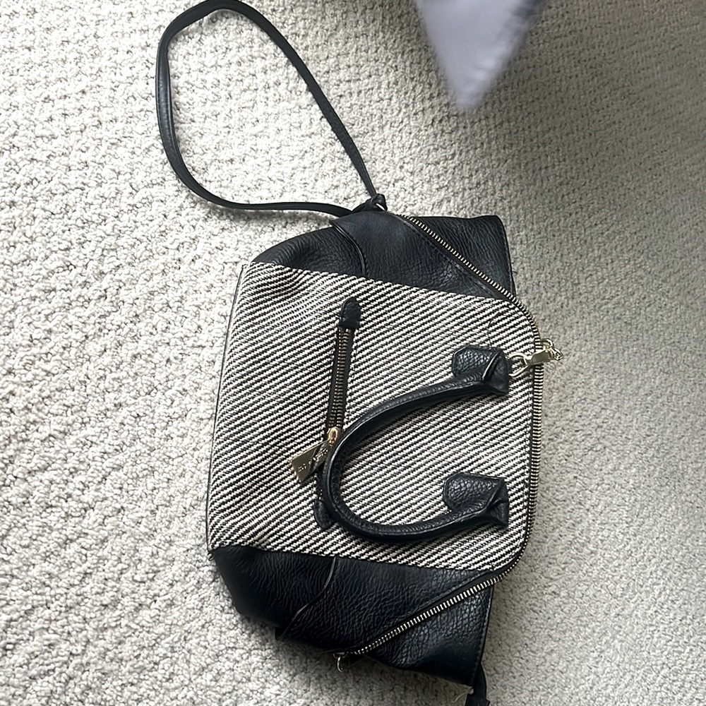 Never used just without a tag one big pocket with side pockets inside.